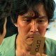 Lee Jung-jae as Seong Gi-hun looks at the business card from Squid Game.